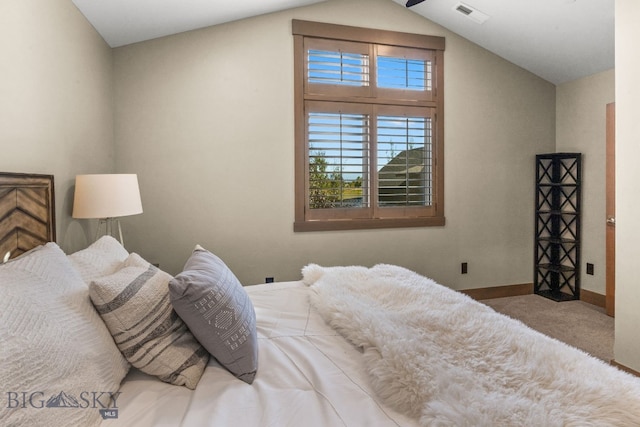 carpeted bedroom with vaulted ceiling