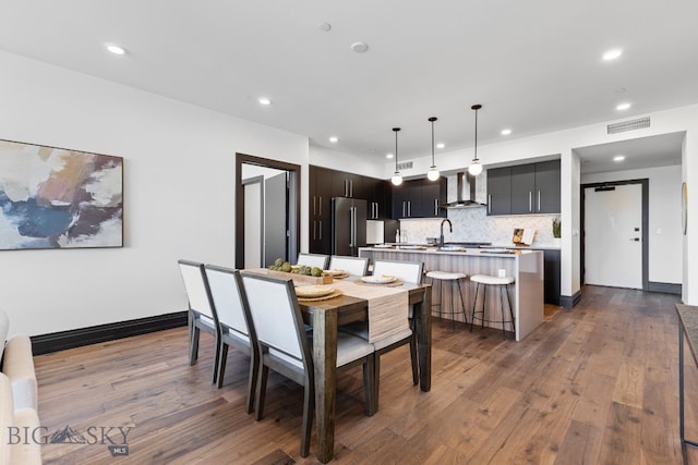 dining area with sink and dark hardwood / wood-style flooring