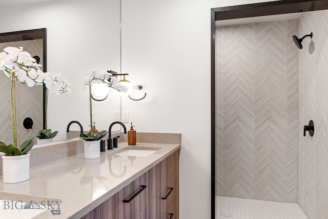 bathroom with vanity and a shower