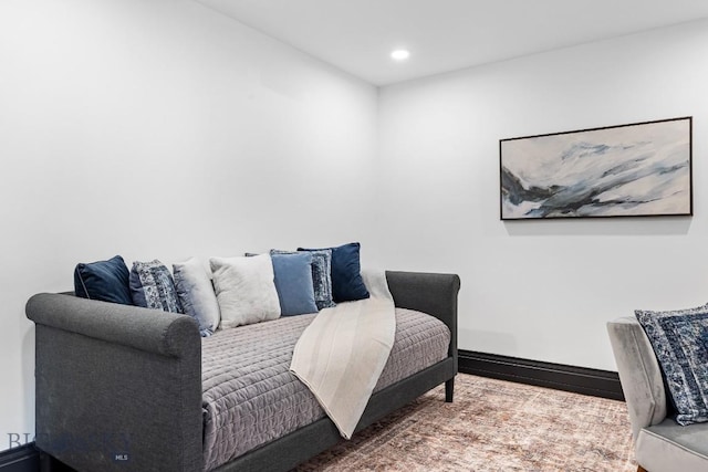 living area featuring baseboards and recessed lighting