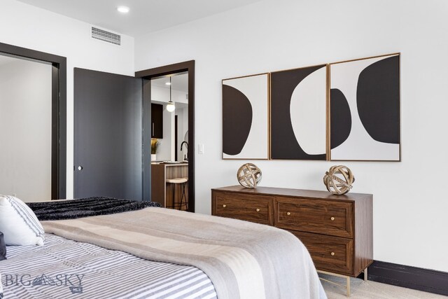 bedroom featuring a closet and light colored carpet