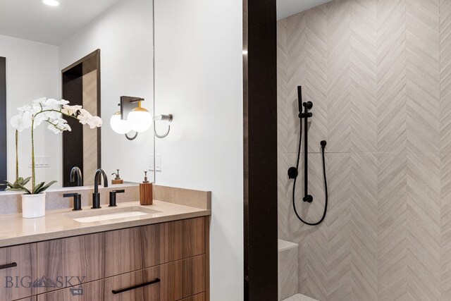 bathroom with walk in shower and vanity