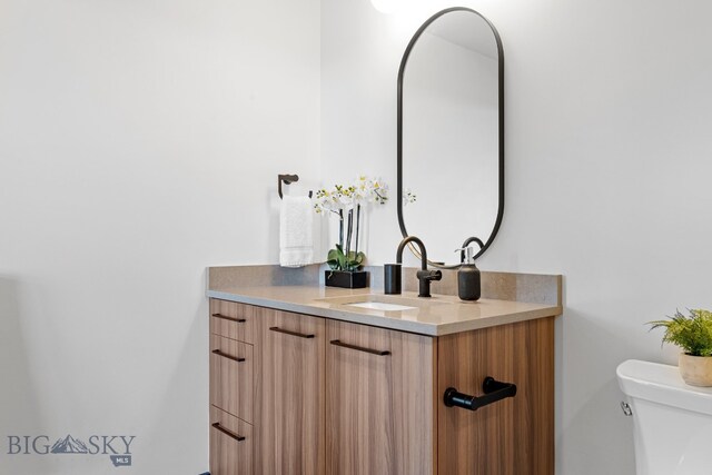 bathroom featuring vanity and toilet