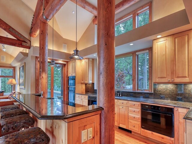 3686 Pinewood Dr, Big Sky, MT 59716 - kitchen featuring black appliances, decorative columns, backsplash, high vaulted ceiling, and recessed lighting