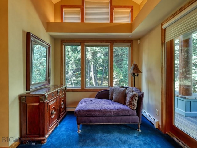 3686 Pinewood Dr, Big Sky, MT 59716 - living area featuring a baseboard radiator, dark colored carpet, healthy amount of natural light, and a towering ceiling