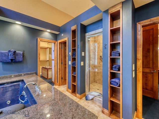 bathroom featuring built in features, tile patterned flooring, and an enclosed shower