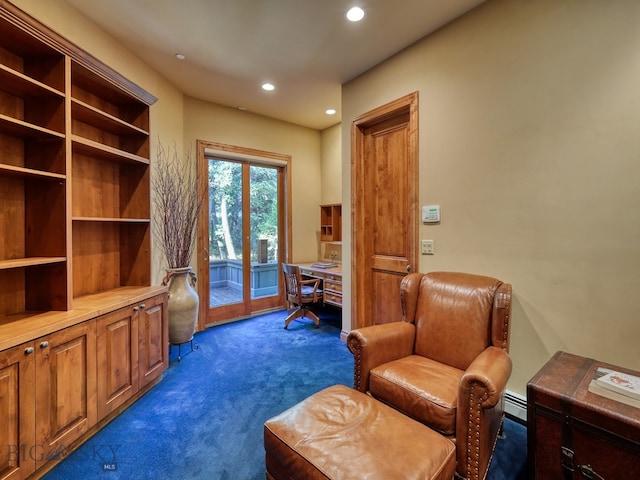 living area featuring baseboard heating and dark carpet