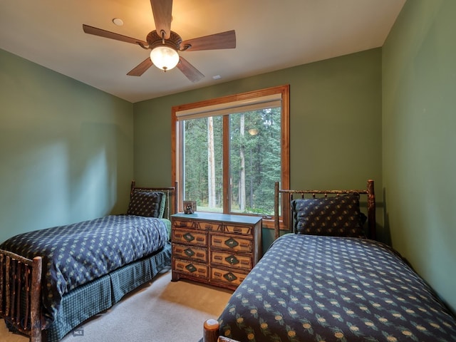 bedroom with ceiling fan and light colored carpet