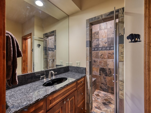 bathroom featuring vanity and a shower with shower door