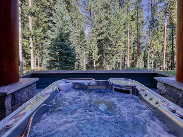 3686 Pinewood Dr, Big Sky, MT 59716 - view of patio with a hot tub and a wooded view
