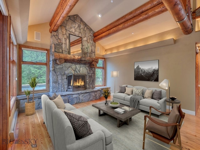 living room featuring a baseboard radiator, lofted ceiling with beams, a stone fireplace, and light hardwood / wood-style floors