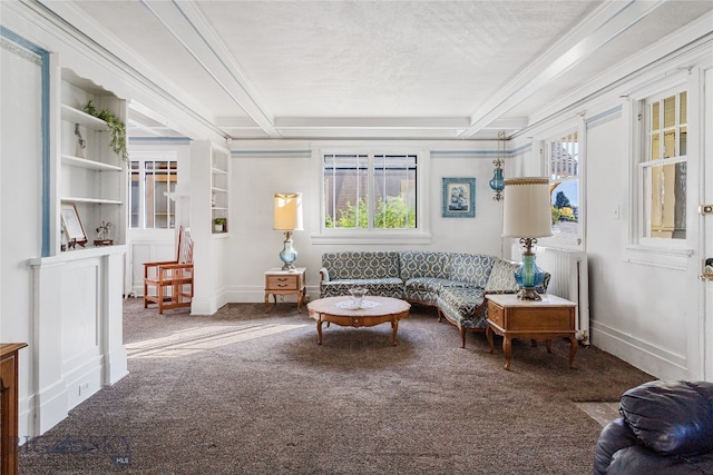 living room featuring ornamental molding, beamed ceiling, carpet flooring, and a textured ceiling