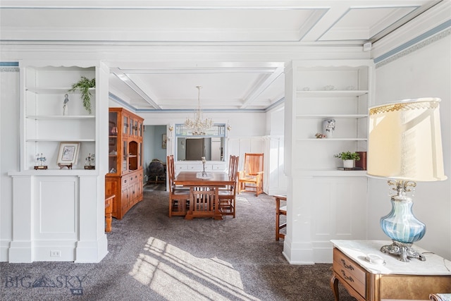 dining space featuring ornamental molding, an inviting chandelier, built in features, and dark colored carpet