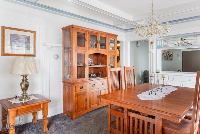 dining room with an inviting chandelier, beam ceiling, and dark colored carpet