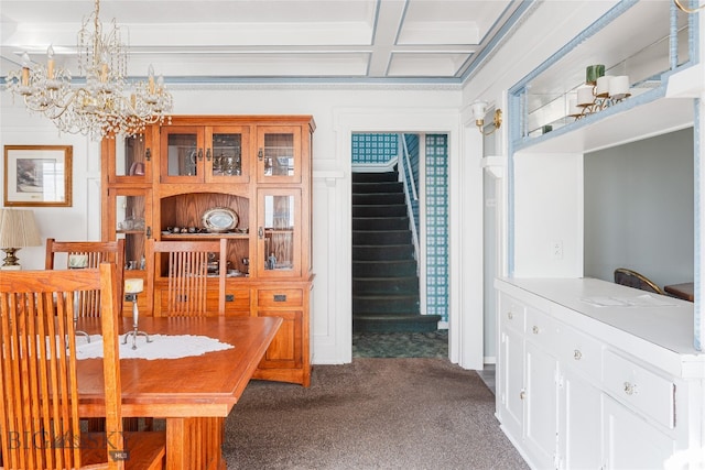 carpeted dining space featuring coffered ceiling and beamed ceiling