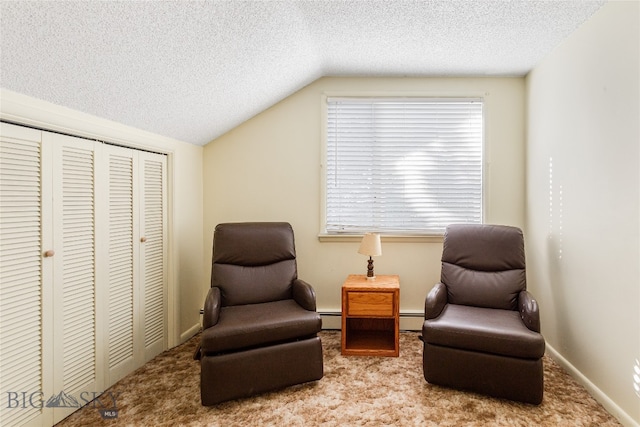 sitting room featuring light colored carpet, lofted ceiling, and baseboard heating