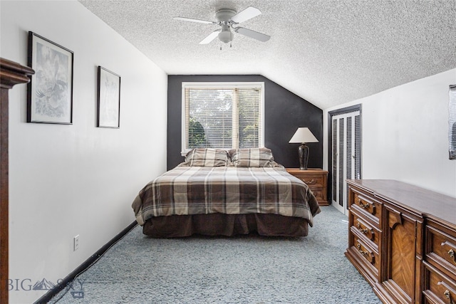 bedroom featuring ceiling fan, a textured ceiling, lofted ceiling, and carpet