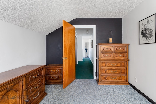 bedroom with a textured ceiling and light carpet