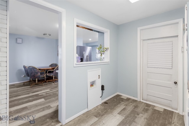 washroom featuring hookup for a washing machine and hardwood / wood-style flooring