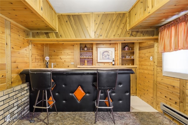 interior space featuring a baseboard heating unit and wooden walls