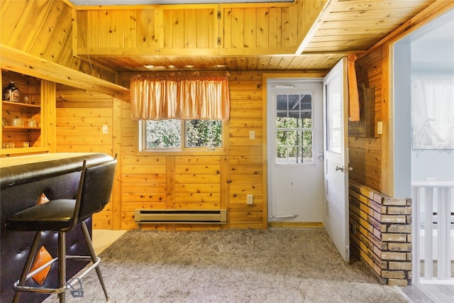 home office featuring wood walls, a baseboard heating unit, and a healthy amount of sunlight