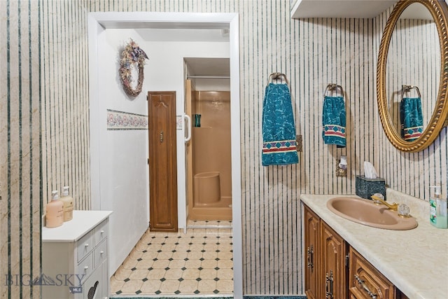 bathroom with walk in shower and vanity