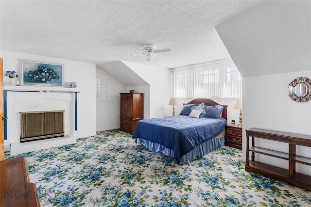 bedroom featuring lofted ceiling, ceiling fan, carpet floors, and a textured ceiling