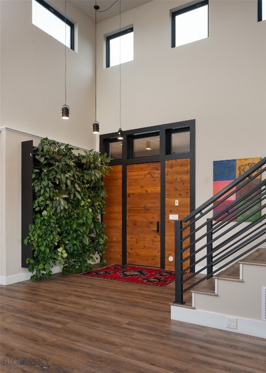 interior space featuring a high ceiling and hardwood / wood-style floors