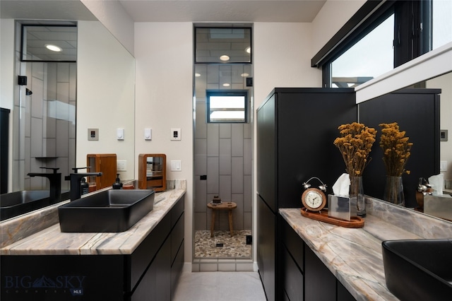 bathroom featuring vanity, tile patterned flooring, and a shower with shower door