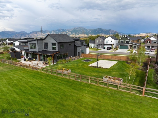 exterior space featuring a lawn and a mountain view