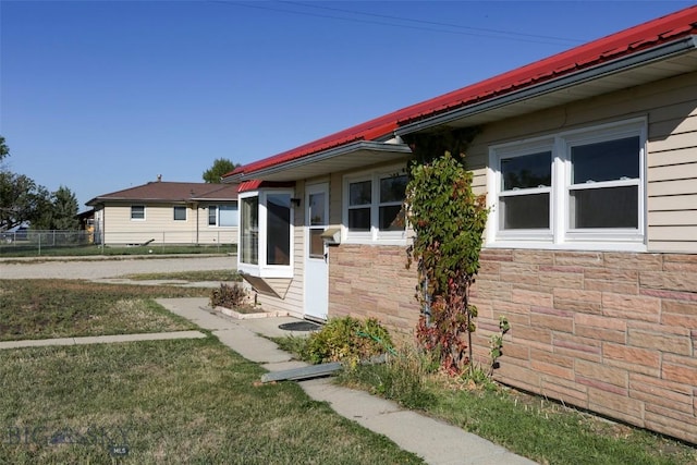 1112 Pritchard NW, Harlowton, MT 59036 - view of home's exterior featuring stone siding and metal roof
