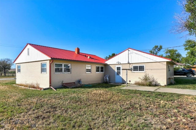 1112 Pritchard NW, Harlowton, MT 59036 - back of house with a yard, a chimney, and metal roof