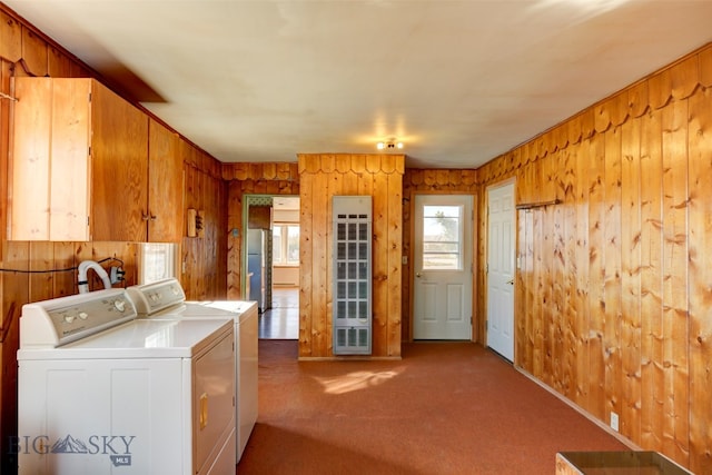 washroom with wooden walls, carpet, and independent washer and dryer