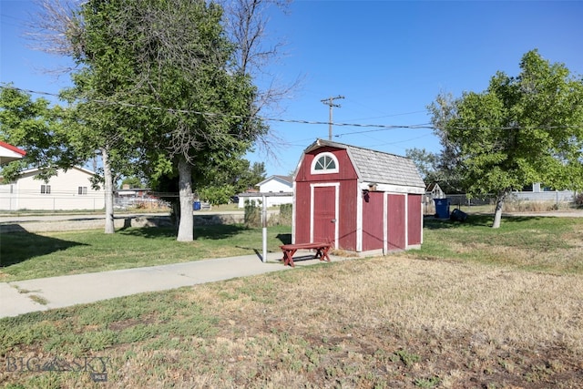 view of outbuilding featuring a yard