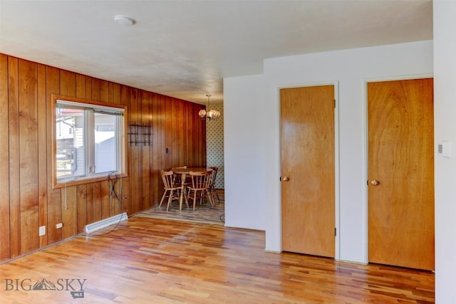 1112 Pritchard NW, Harlowton, MT 59036 - empty room featuring a chandelier, wood finished floors, and wood walls