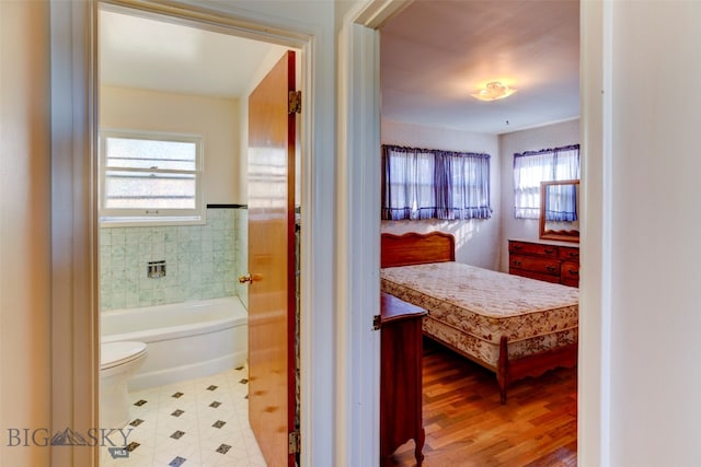 bathroom with toilet and hardwood / wood-style flooring