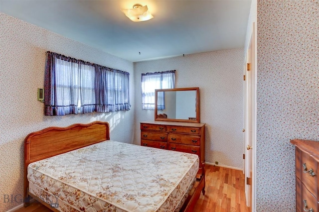1112 Pritchard NW, Harlowton, MT 59036 - bedroom with wood finished floors and wallpapered walls