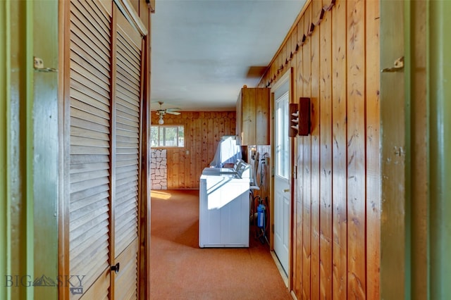 corridor with wood walls and light colored carpet