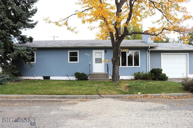 ranch-style house with a garage and a front lawn