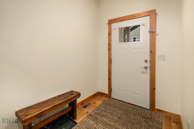 doorway with wood-type flooring