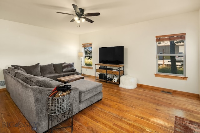 living room featuring a healthy amount of sunlight, ceiling fan, and hardwood / wood-style flooring