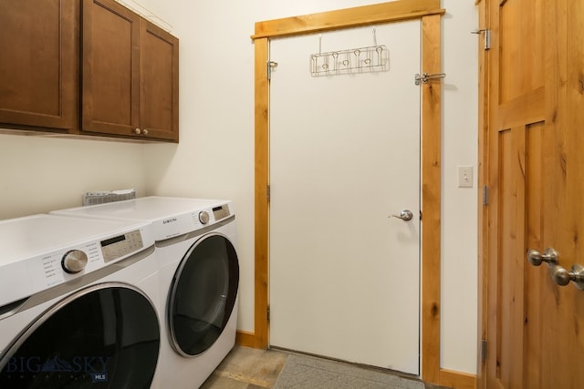 washroom featuring cabinets and washing machine and clothes dryer