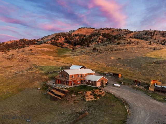 aerial view at dusk featuring a mountain view