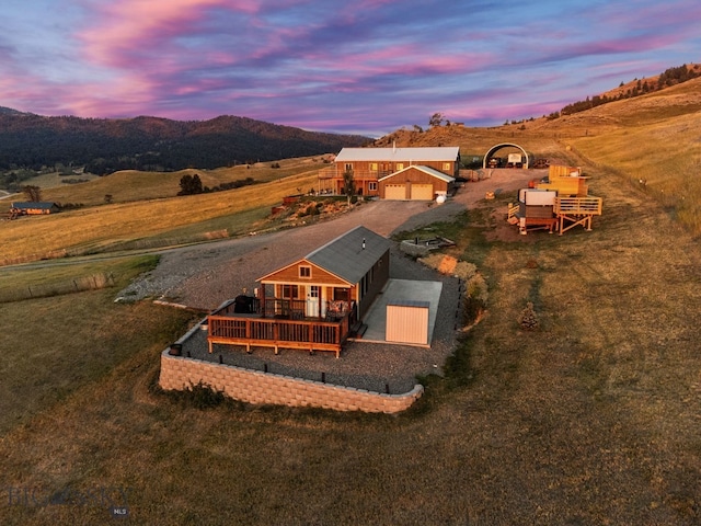 aerial view at dusk featuring a mountain view