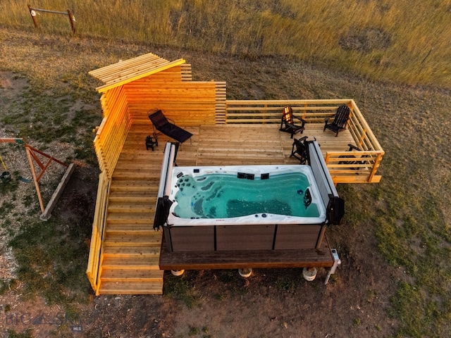 exterior space with an outdoor hot tub and a wooden deck