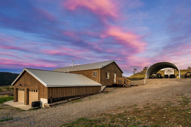 31 Bull Run Rd, Livingston, MT 59047 - property exterior at dusk with an outdoor structure, a detached garage, and metal roof