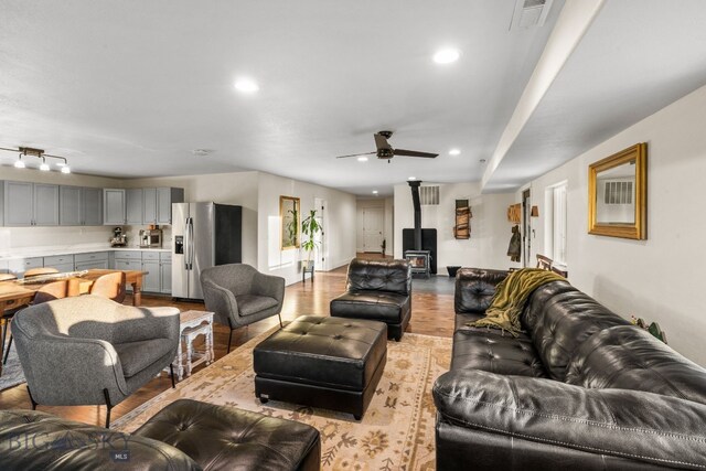31 Bull Run Rd, Livingston, MT 59047 - living area featuring a ceiling fan, a wood stove, light wood finished floors, visible vents, and recessed lighting