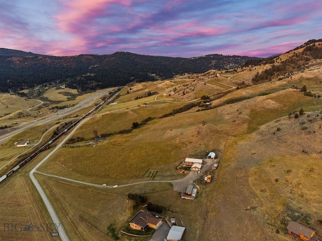 aerial view at dusk with a rural view and a mountain view