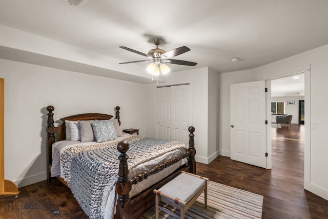 bedroom with a closet, ceiling fan, and dark hardwood / wood-style flooring