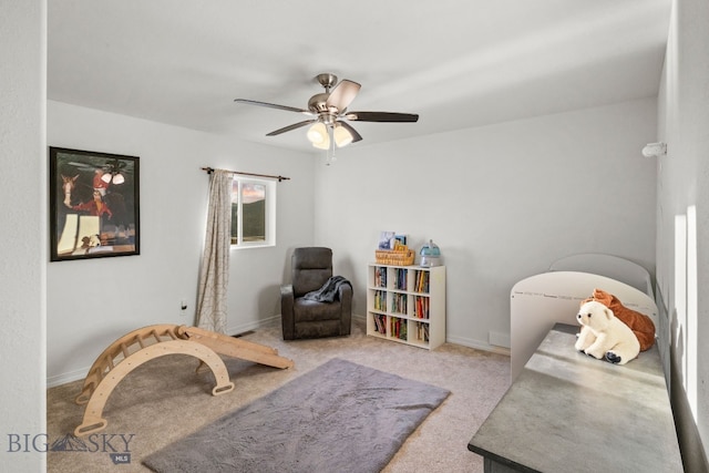 sitting room with ceiling fan and light colored carpet